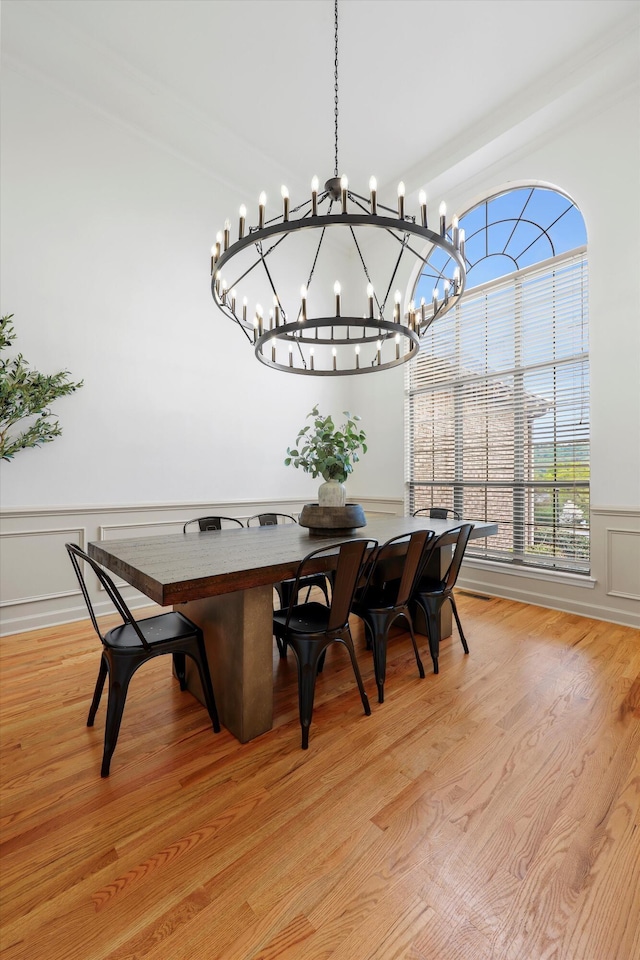 9401 Lazy Circles Dr, Ooltewah, TN 37363 - dining space featuring wainscoting, a chandelier, light wood-type flooring, and a decorative wall