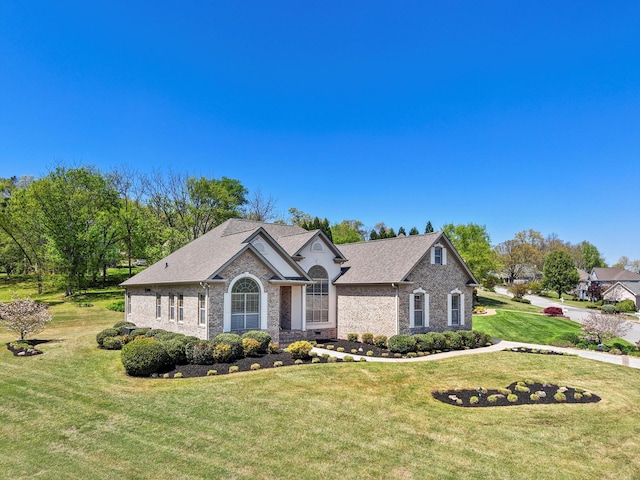 9401 Lazy Circles Dr, Ooltewah, TN 37363 - view of front of house with a front yard, brick siding, and a shingled roof
