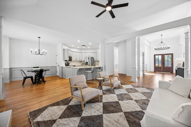 9401 Lazy Circles Dr, Ooltewah, TN 37363 - living area featuring a chandelier, light wood-style floors, recessed lighting, ornate columns, and a ceiling fan
