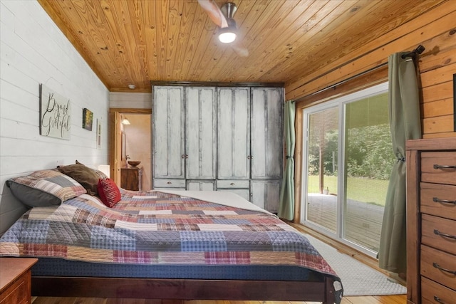 539 Bland Hollow Rd, Hohenwald, TN 38462 - bedroom with access to exterior, wooden ceiling, wood walls, and wood finished floors