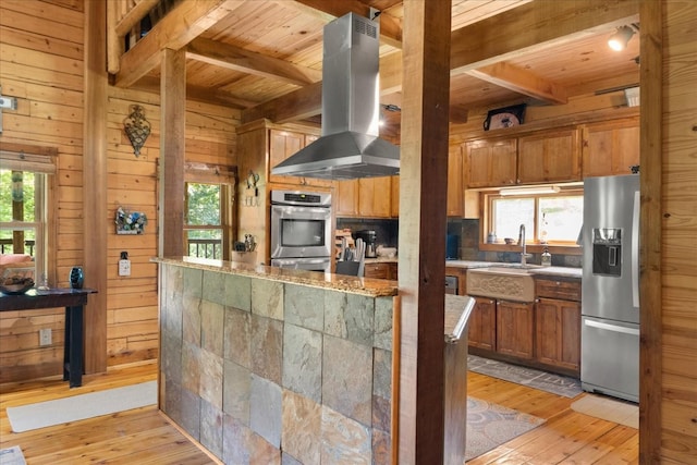 539 Bland Hollow Rd, Hohenwald, TN 38462 - kitchen with appliances with stainless steel finishes, ventilation hood, a wood ceiling with exposed beams, wooden walls, and light wood-style flooring