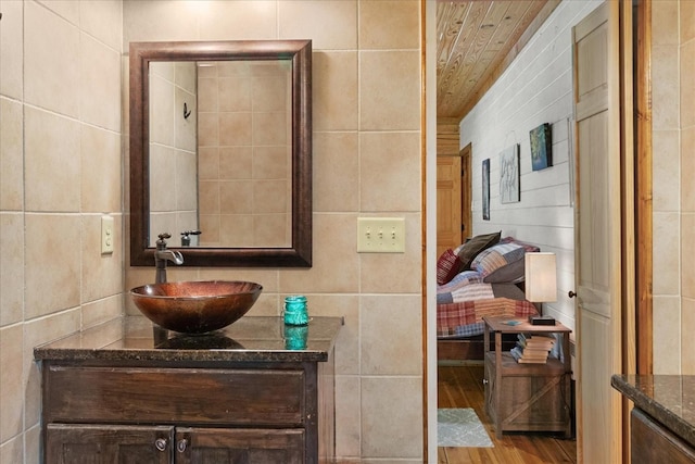 539 Bland Hollow Rd, Hohenwald, TN 38462 - bathroom with tile walls, vanity, wood ceiling, and wood finished floors