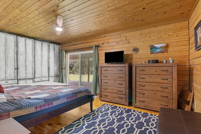 539 Bland Hollow Rd, Hohenwald, TN 38462 - bedroom with access to outside, wooden walls, light wood-style flooring, and wooden ceiling