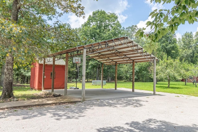 539 Bland Hollow Rd, Hohenwald, TN 38462 - view of parking featuring gravel driveway, a detached carport, and view of scattered trees