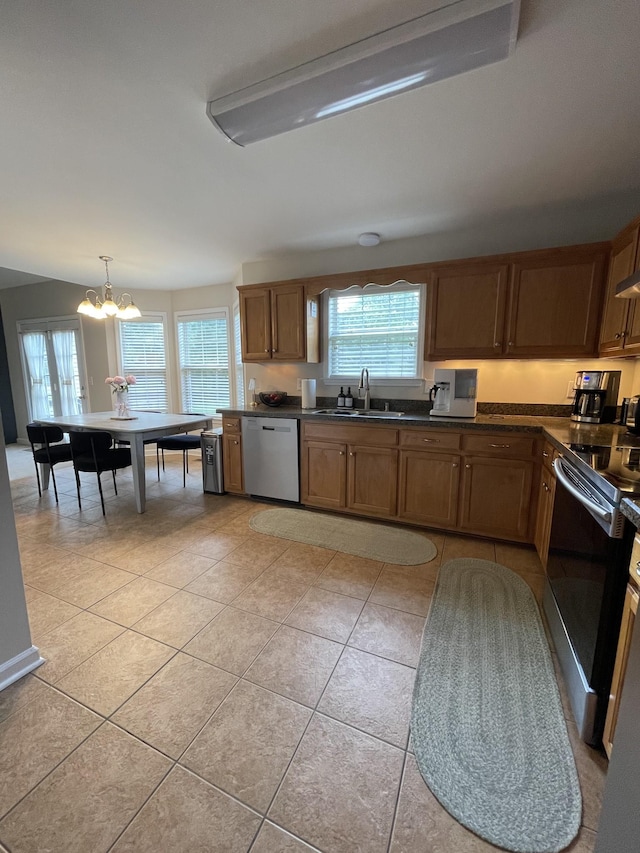 1253 Annapolis Cir, Thompsons Station, TN 37179 - kitchen with stainless steel appliances, a chandelier, dark countertops, and light tile patterned floors