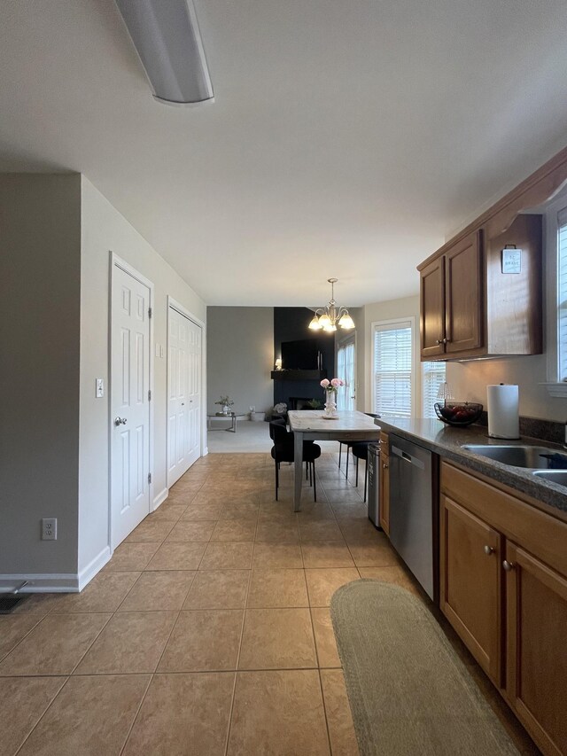 1253 Annapolis Cir, Thompsons Station, TN 37179 - kitchen with stainless steel dishwasher, dark countertops, a chandelier, light tile patterned floors, and hanging light fixtures