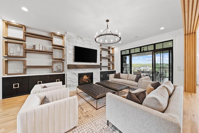 6004 Pelican Way, College Grove, TN 37046 - living room with light wood-type flooring, a chandelier, a premium fireplace, and recessed lighting