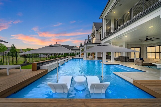 6004 Pelican Way, College Grove, TN 37046 - pool at dusk with a gazebo, outdoor lounge area, a deck, ceiling fan, and a patio area