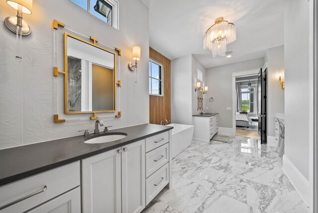 6004 Pelican Way, College Grove, TN 37046 - full bathroom featuring ensuite bathroom, a freestanding bath, vanity, a chandelier, and marble finish flooring