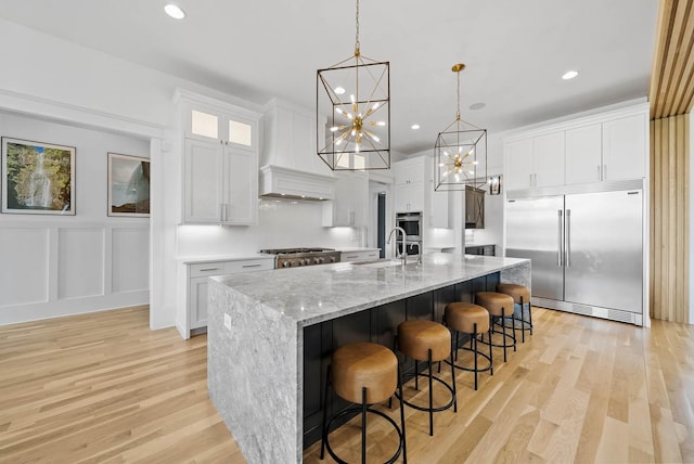 6004 Pelican Way, College Grove, TN 37046 - kitchen with built in fridge, a chandelier, white cabinets, light wood-type flooring, and recessed lighting