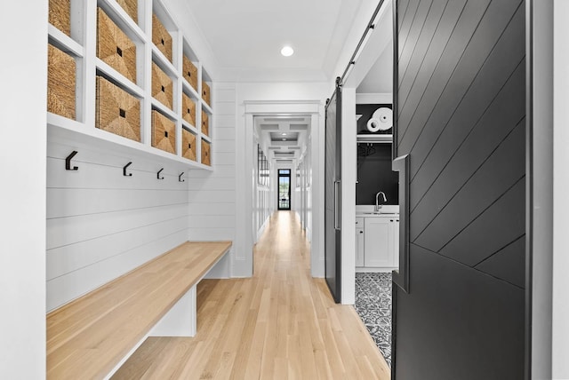 6004 Pelican Way, College Grove, TN 37046 - mudroom featuring a barn door, light wood-type flooring, and crown molding