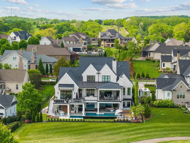 6004 Pelican Way, College Grove, TN 37046 - back of property with a residential view, a balcony, an outdoor pool, a standing seam roof, and a patio