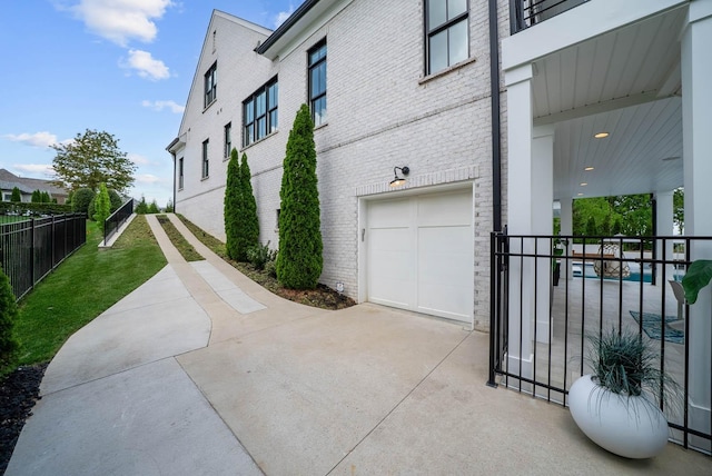 6004 Pelican Way, College Grove, TN 37046 - view of side of home featuring an attached garage, brick siding, and driveway