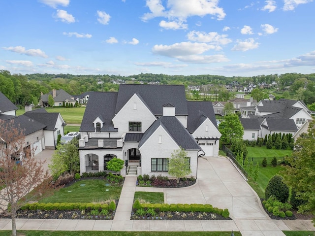 6004 Pelican Way, College Grove, TN 37046 - french provincial home featuring concrete driveway, a residential view, a front lawn, and a standing seam roof