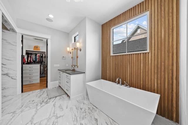6004 Pelican Way, College Grove, TN 37046 - full bath with vanity, a freestanding tub, marble finish floors, a walk in closet, and healthy amount of natural light