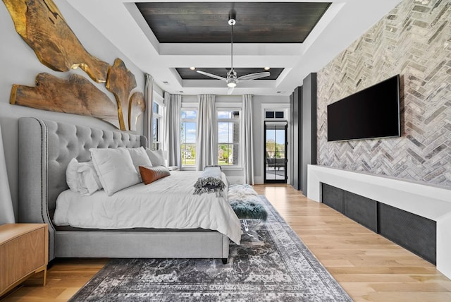 6004 Pelican Way, College Grove, TN 37046 - bedroom with access to outside, a tray ceiling, wood finished floors, ceiling fan, and an accent wall
