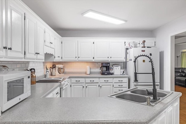 161 Cumberland Oaks Dr, Tullahoma, TN 37388 - kitchen with white appliances, white cabinetry, tasteful backsplash, and light countertops