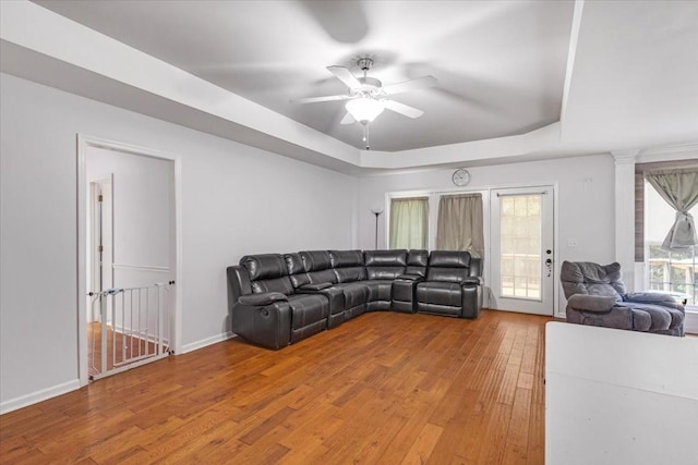 161 Cumberland Oaks Dr, Tullahoma, TN 37388 - living room with light wood finished floors, a tray ceiling, ceiling fan, and ornate columns