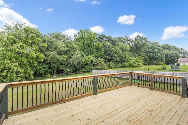 161 Cumberland Oaks Dr, Tullahoma, TN 37388 - deck with a fenced backyard, a trampoline, and view of wooded area