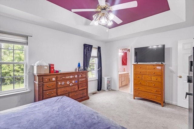 161 Cumberland Oaks Dr, Tullahoma, TN 37388 - carpeted bedroom featuring a raised ceiling, connected bathroom, and ceiling fan