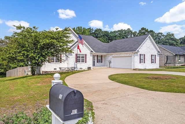 161 Cumberland Oaks Dr, Tullahoma, TN 37388 - view of front of house featuring curved driveway, a trampoline, a garage, and brick siding