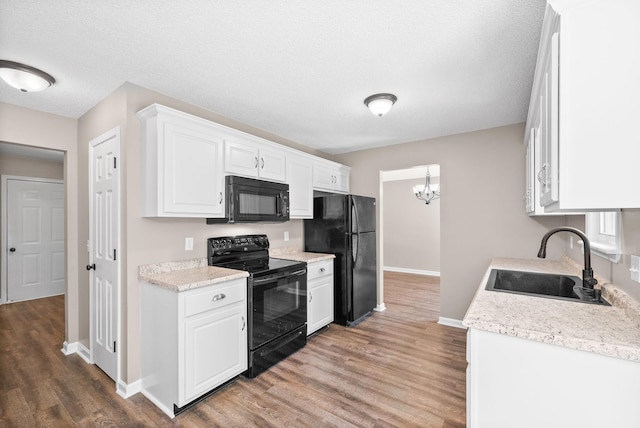 1155 Delmont Church Rd, Cadiz, KY 42211 - kitchen featuring black appliances, wood finished floors, light countertops, white cabinetry, and a textured ceiling