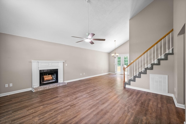 1155 Delmont Church Rd, Cadiz, KY 42211 - unfurnished living room featuring wood finished floors, ceiling fan, a fireplace with raised hearth, high vaulted ceiling, and stairs