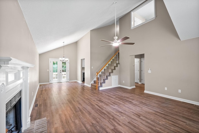1155 Delmont Church Rd, Cadiz, KY 42211 - unfurnished living room with a fireplace with flush hearth, a ceiling fan, a chandelier, wood finished floors, and stairs