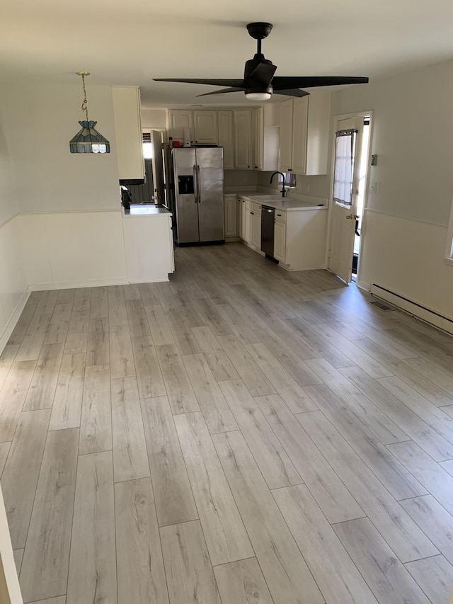 1206 Park Mere Dr, Columbia, TN 38401 - kitchen with appliances with stainless steel finishes, ceiling fan, light wood finished floors, light countertops, and decorative light fixtures