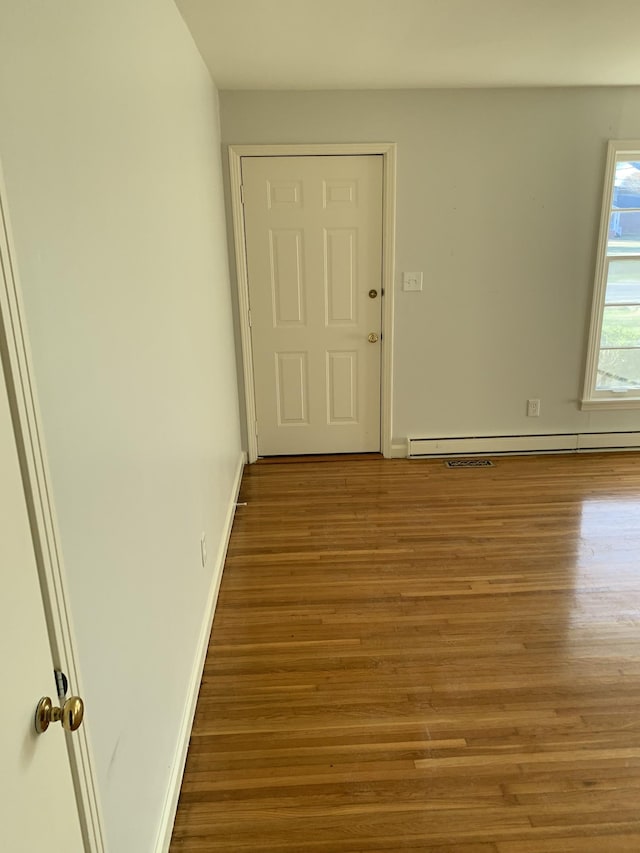1206 Park Mere Dr, Columbia, TN 38401 - spare room featuring a baseboard heating unit and wood finished floors