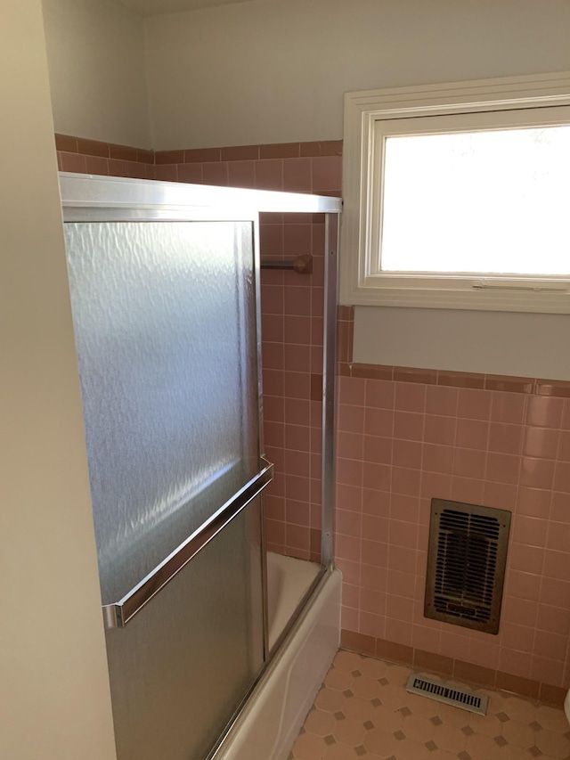 1206 Park Mere Dr, Columbia, TN 38401 - bathroom featuring shower / bath combination with glass door, tile walls, and a fireplace
