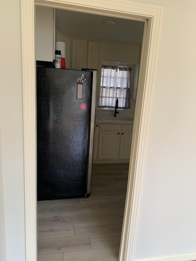 1206 Park Mere Dr, Columbia, TN 38401 - kitchen featuring freestanding refrigerator, light wood-style flooring, and white cabinets