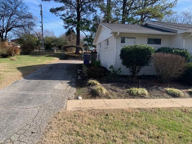 1206 Park Mere Dr, Columbia, TN 38401 - view of home's exterior with driveway, a carport, brick siding, and a yard