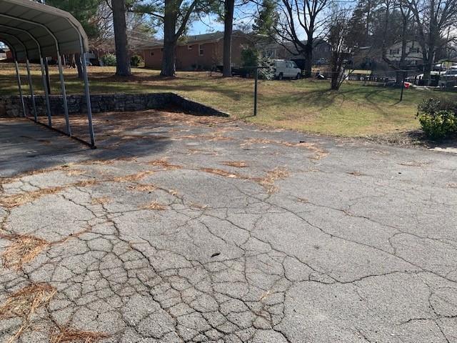 1206 Park Mere Dr, Columbia, TN 38401 - view of grassy yard with a detached carport and asphalt driveway