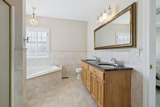 6913 Zion Crossing Ct, Columbia, TN 38401 - bathroom with tile walls, double vanity, a garden tub, tile patterned flooring, and a wainscoted wall