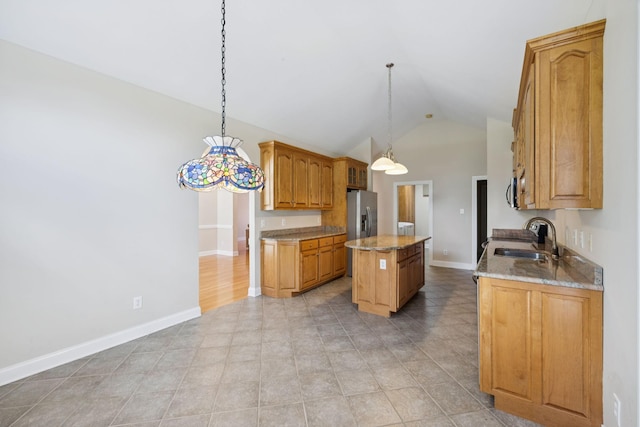 6913 Zion Crossing Ct, Columbia, TN 38401 - kitchen featuring a kitchen island, vaulted ceiling, light stone countertops, pendant lighting, and stainless steel refrigerator with ice dispenser