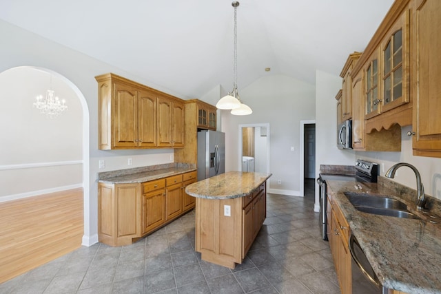 6913 Zion Crossing Ct, Columbia, TN 38401 - kitchen with appliances with stainless steel finishes, a center island, vaulted ceiling, a chandelier, and glass insert cabinets