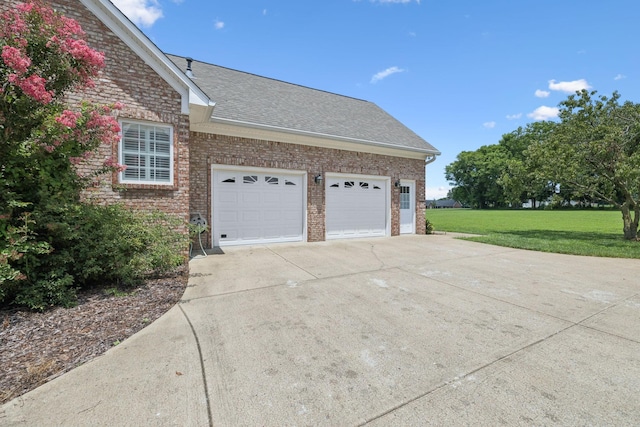 6913 Zion Crossing Ct, Columbia, TN 38401 - view of home's exterior featuring brick siding, a lawn, an attached garage, roof with shingles, and concrete driveway