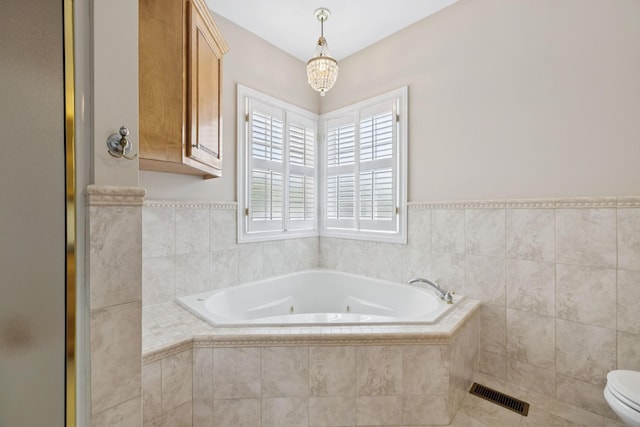 6913 Zion Crossing Ct, Columbia, TN 38401 - full bathroom with a tub with jets, a shower stall, and a chandelier