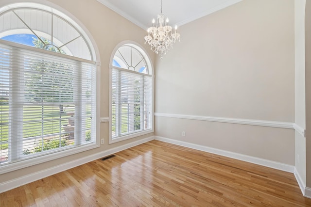 6913 Zion Crossing Ct, Columbia, TN 38401 - empty room with a chandelier, plenty of natural light, wood finished floors, and crown molding