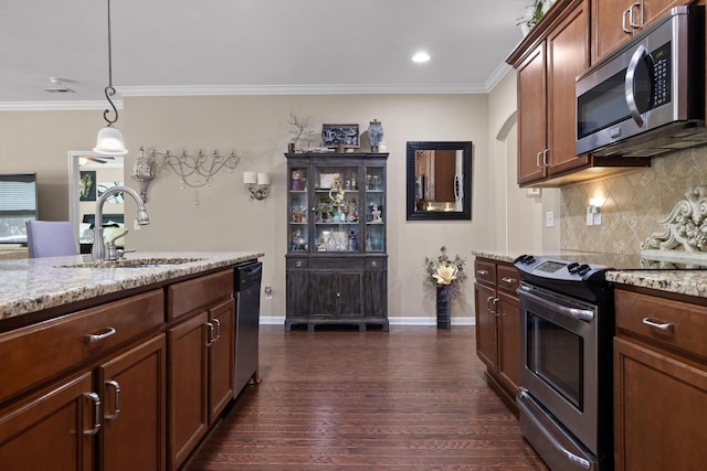 7560 Hampstead Hall Dr, Ooltewah, TN 37363 - kitchen featuring appliances with stainless steel finishes, decorative backsplash, dark wood-type flooring, ornamental molding, and light stone countertops