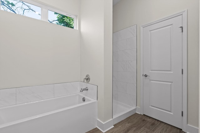 212 Mcbrien Rd, Chattanooga, TN 37411 - full bath with a garden tub, wood finished floors, and tiled shower