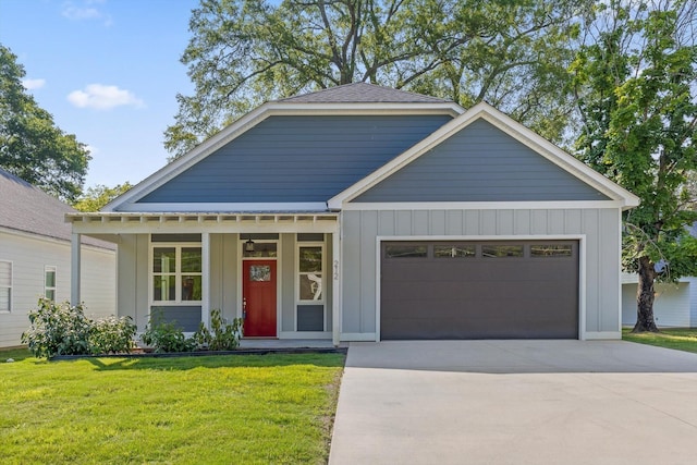 212 Mcbrien Rd, Chattanooga, TN 37411 - view of front of house with board and batten siding, an attached garage, a front lawn, and concrete driveway