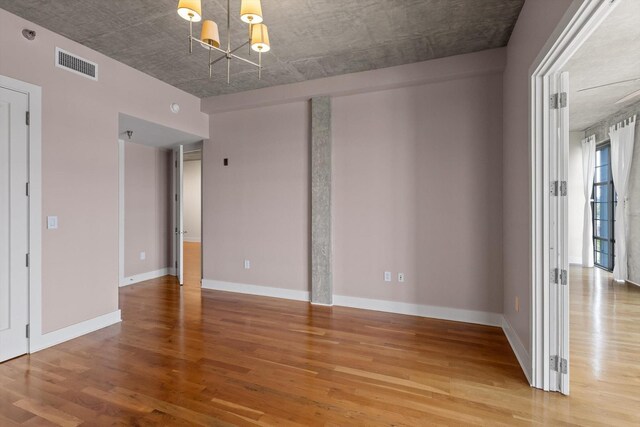 417 Frazier Ave Unit 303, Chattanooga, TN 37405 - spare room featuring a chandelier and light wood-style flooring