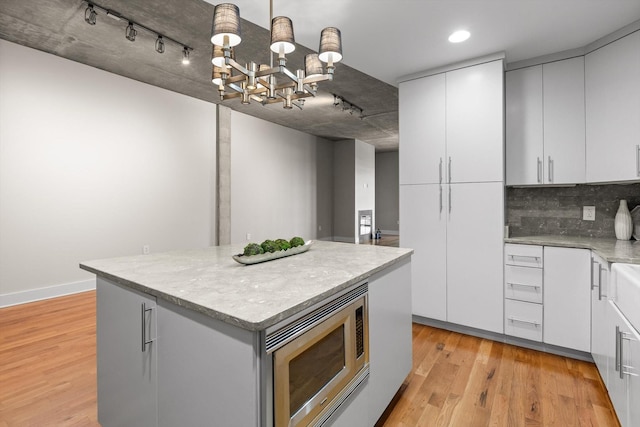 417 Frazier Ave Unit 303, Chattanooga, TN 37405 - kitchen featuring stainless steel microwave, a chandelier, track lighting, light wood-style flooring, and recessed lighting