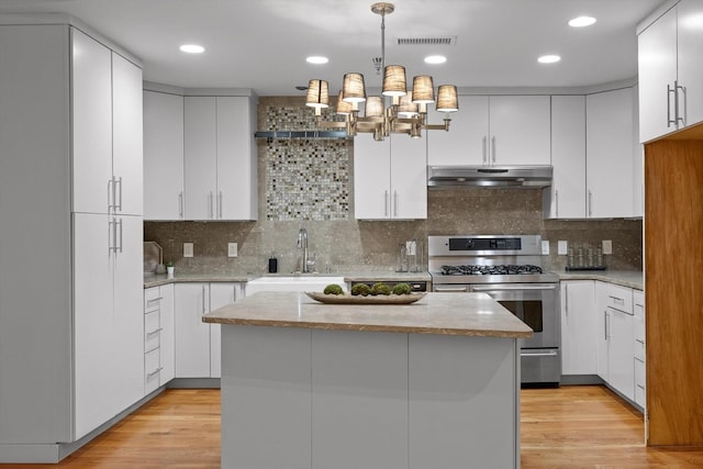 417 Frazier Ave Unit 303, Chattanooga, TN 37405 - kitchen featuring gas range, under cabinet range hood, white cabinets, light wood-type flooring, and recessed lighting