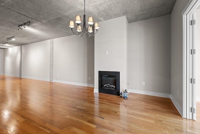 417 Frazier Ave Unit 303, Chattanooga, TN 37405 - unfurnished living room with light wood finished floors, a chandelier, track lighting, and a fireplace