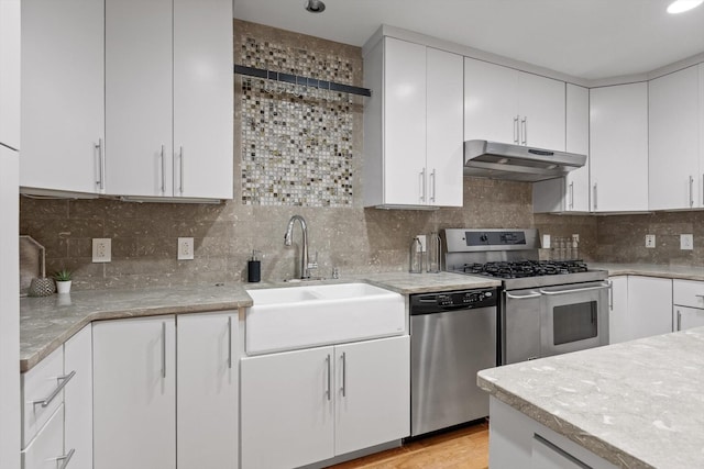 417 Frazier Ave Unit 303, Chattanooga, TN 37405 - kitchen featuring appliances with stainless steel finishes, under cabinet range hood, white cabinetry, and tasteful backsplash