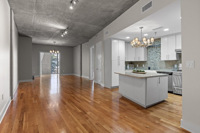 417 Frazier Ave Unit 303, Chattanooga, TN 37405 - kitchen featuring a chandelier, dishwasher, track lighting, and white cabinets