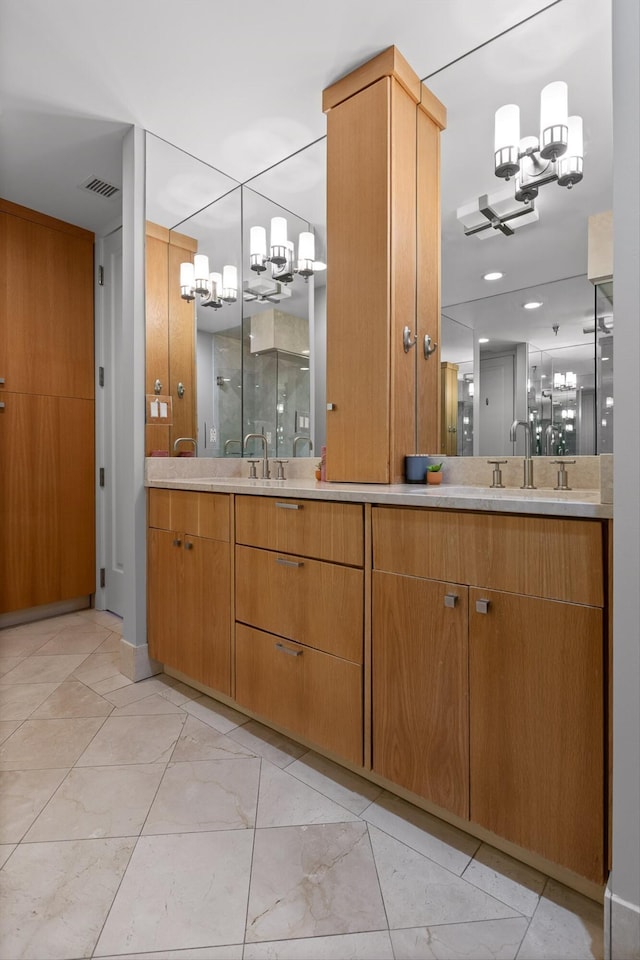 417 Frazier Ave Unit 303, Chattanooga, TN 37405 - bathroom featuring a chandelier, double vanity, and marble finish flooring